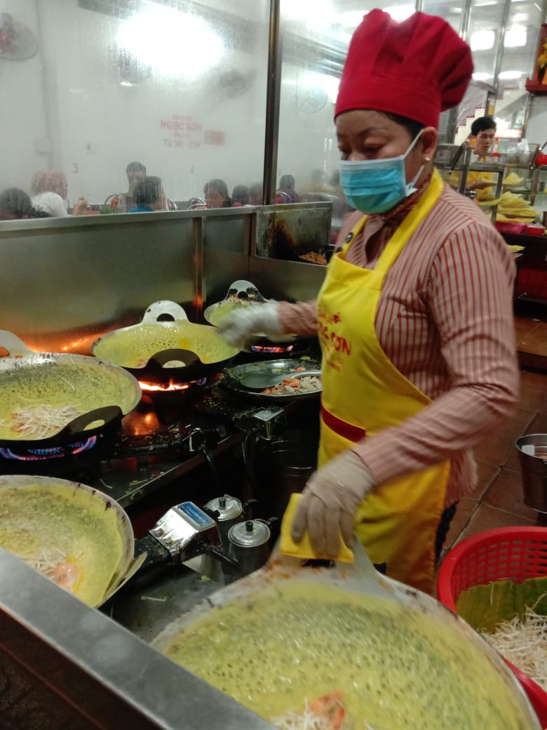 A woman cook in a small family restaurant in Saigon